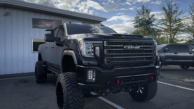 Front-end suspension repair on a lifted truck at High Rollin Customs