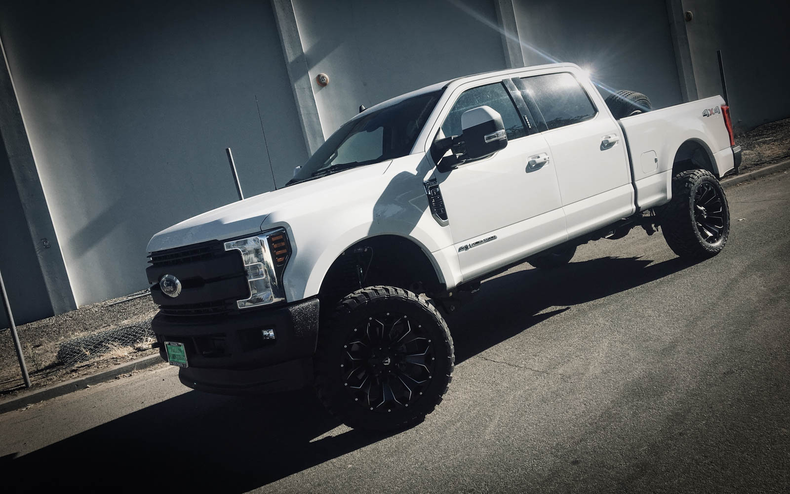 Custom wheels on a lifted truck at High Rollin Customs