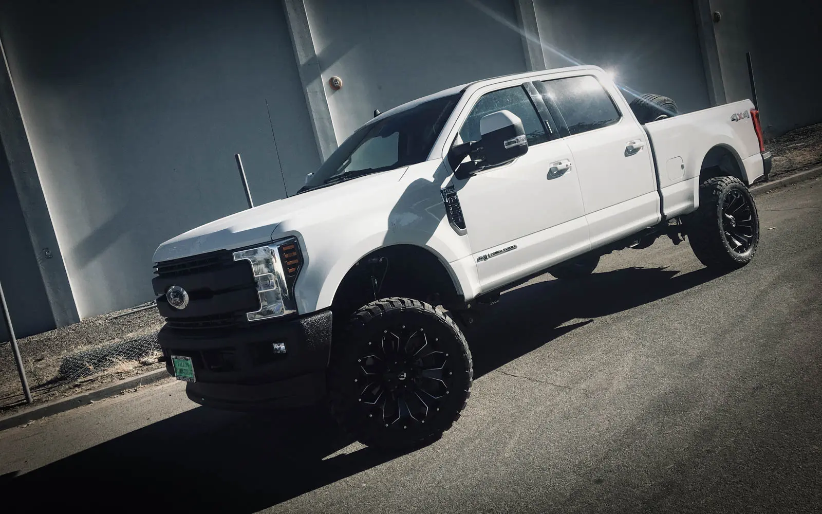 Custom wheels on a lifted truck at High Rollin Customs