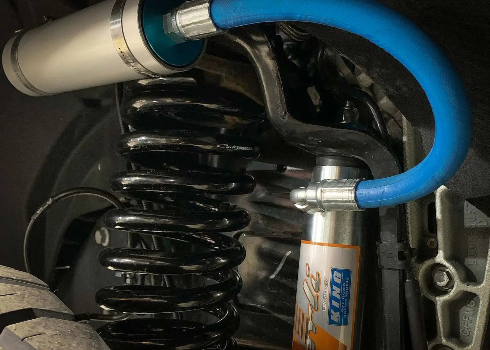 Coilover suspension detail on a lifted truck at High Rollin Customs in Reno